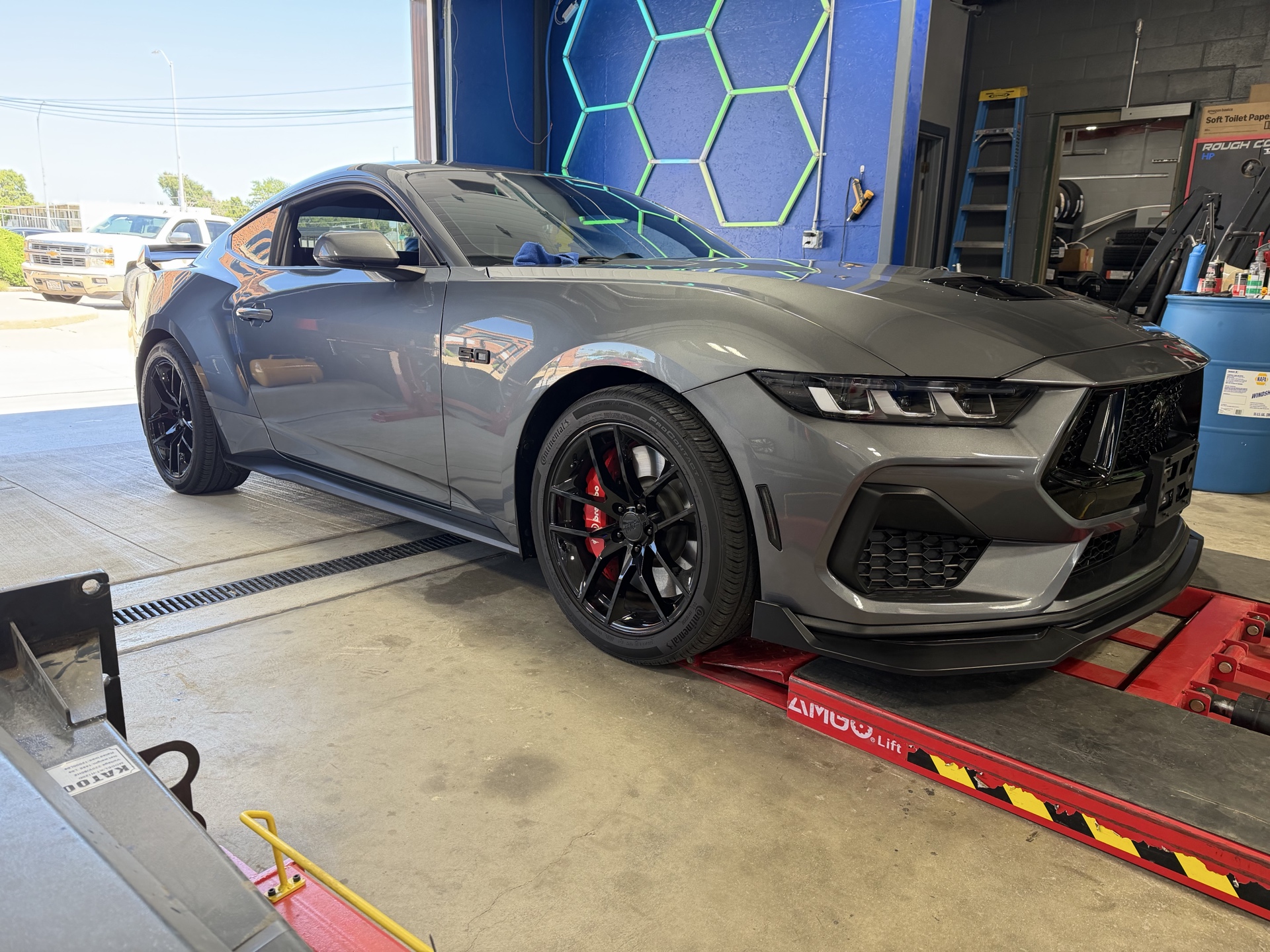 Front three-quarter view of a gray Mustang after ceramic coating