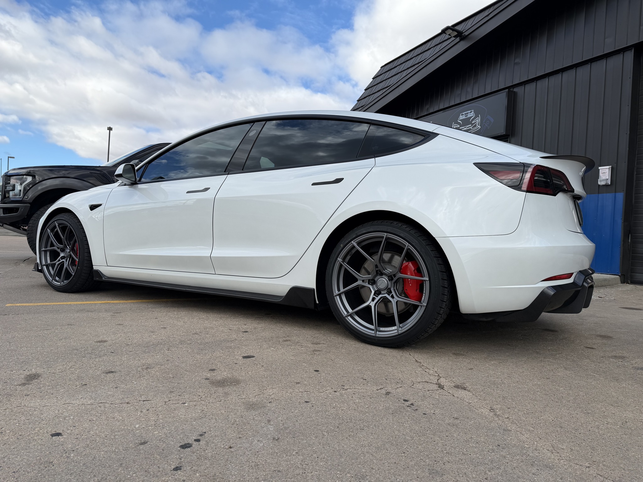 White Tesla Model 3 showing an even glossy finish after detailing