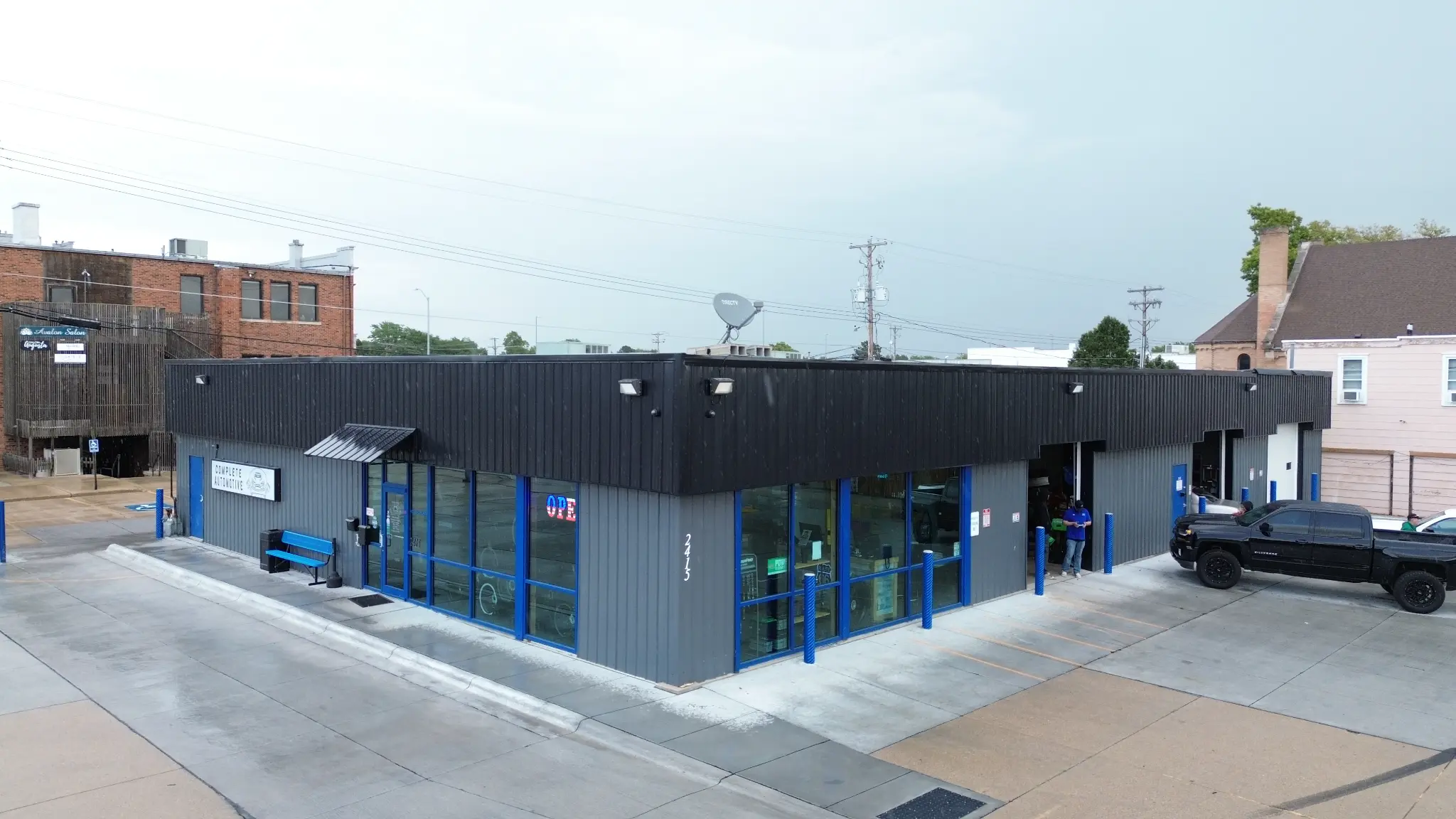 Angled aerial view of the lobby entrance and service-bay corner
