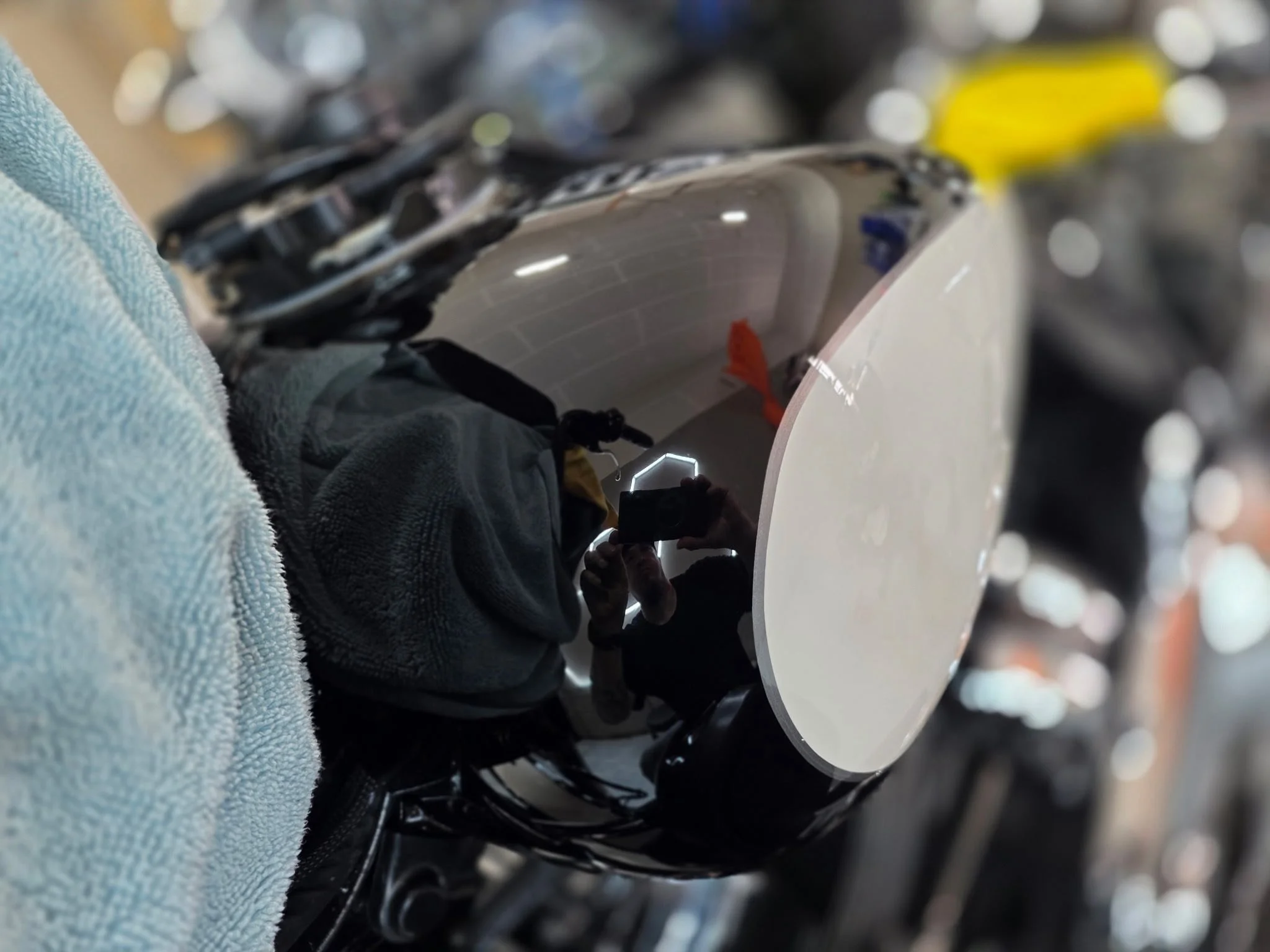 Close-up of a deep reflective mirror finish during professional detailing