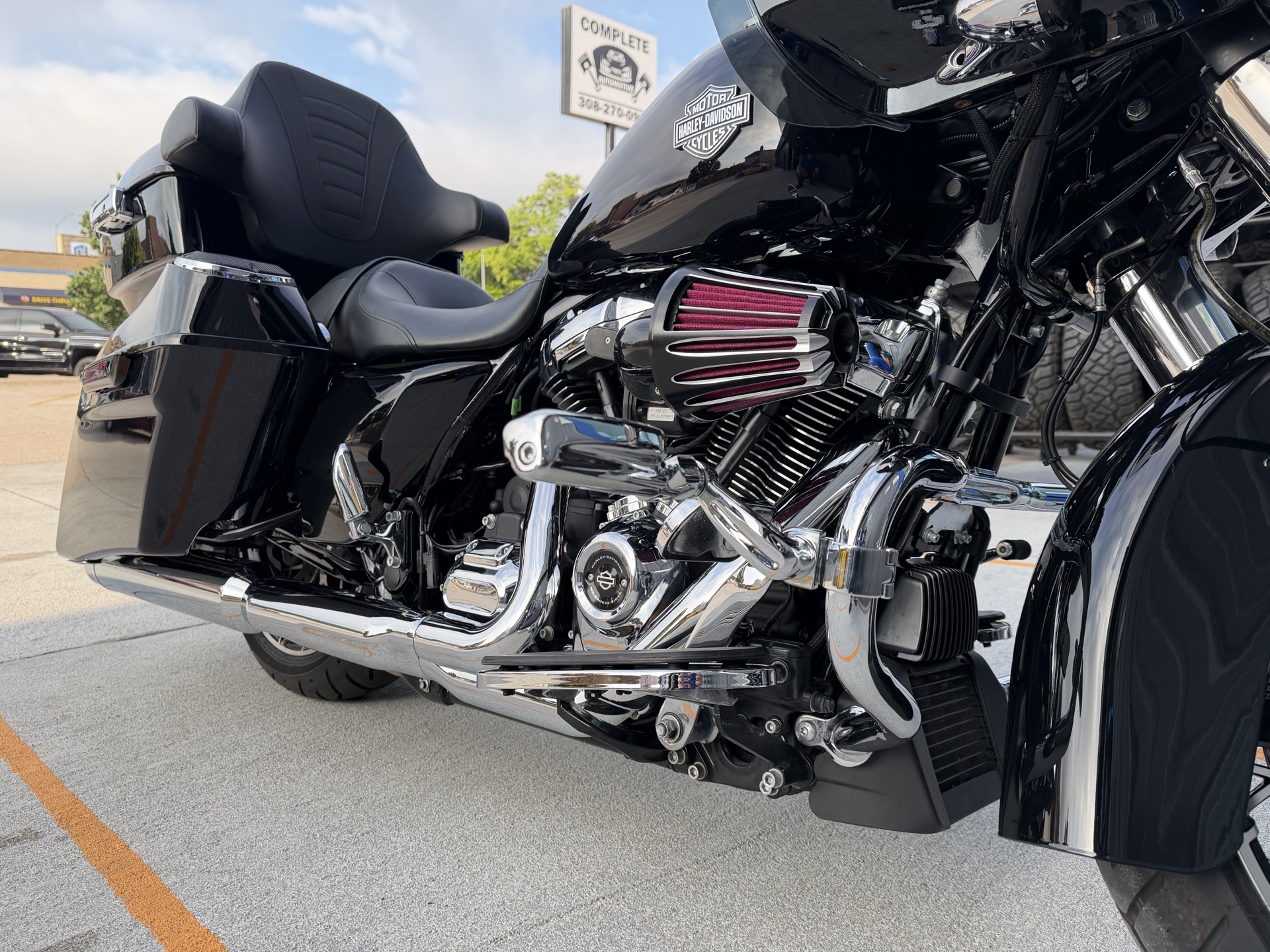 Black touring motorcycle photographed outside Complete Automotive and Tires