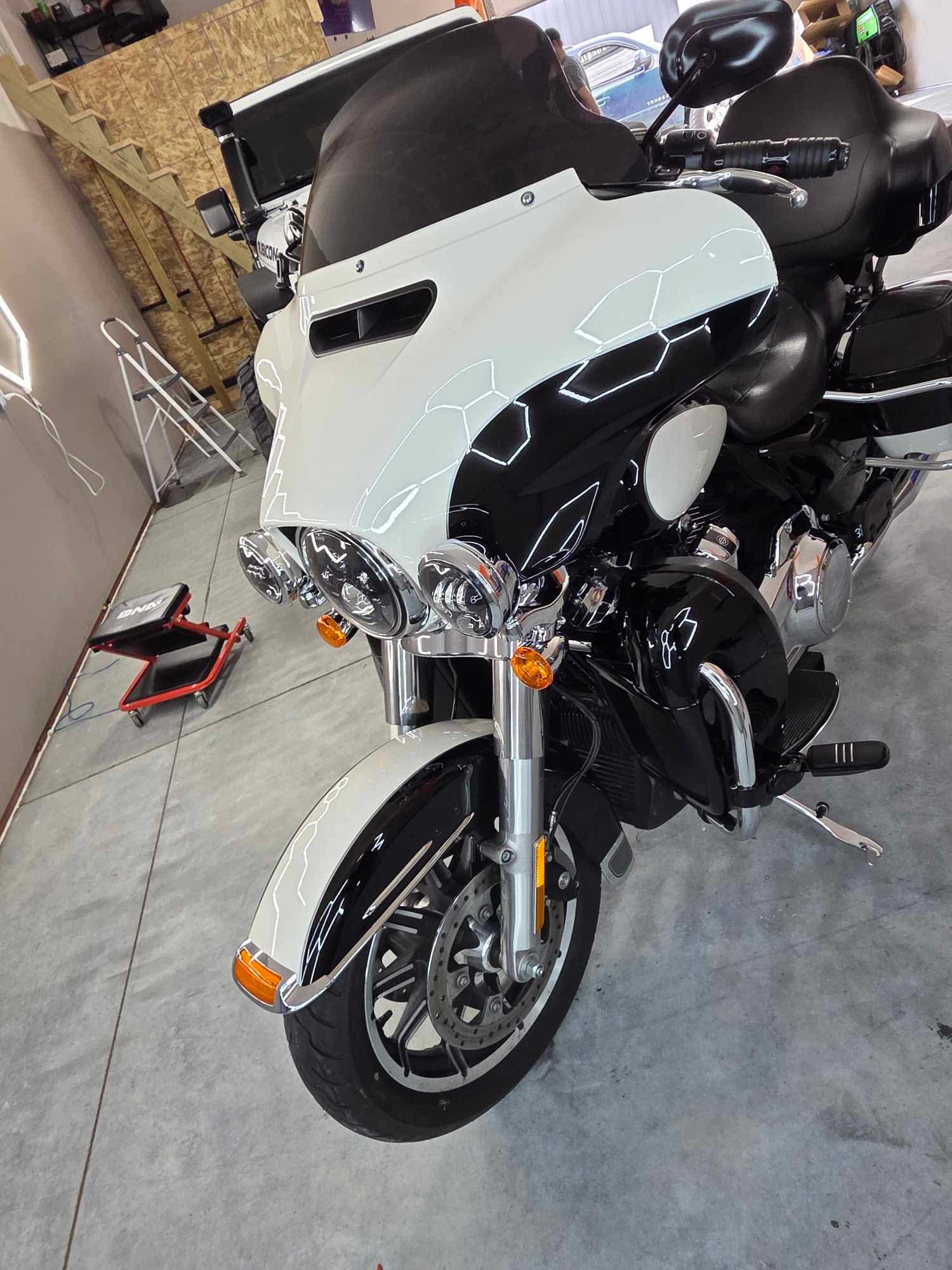 Black-and-white touring motorcycle inside the shop